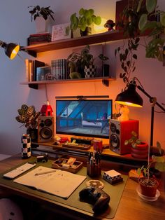 a desk with a computer and various plants on it