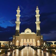 a large white building with two towers at night