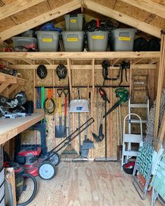 the inside of a shed with tools and other items in it, including buckets