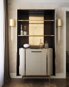 a white cabinet sitting in the corner of a room next to a lamp and window