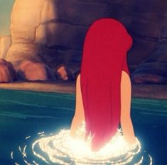 the little mermaid is standing in the water