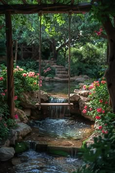 a small waterfall flowing into a pond surrounded by greenery and flowers with a swing hanging from the ceiling