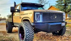 a yellow truck parked in front of a house