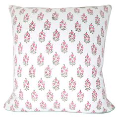 a white pillow with pink flowers on it