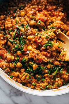 a pot filled with some food and a wooden spoon