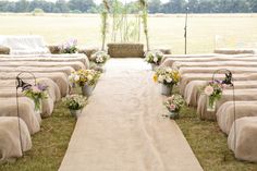 the aisle is lined with chairs and flowers