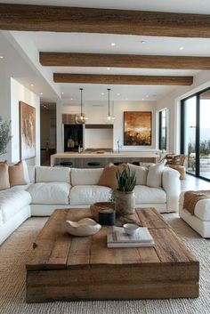 a living room filled with white furniture and lots of windows