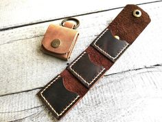 a leather key fobring with two different colors and stitching on the side