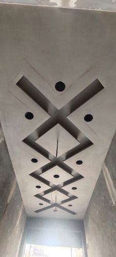 the ceiling is made up of square and rectangle shapes, with holes in them