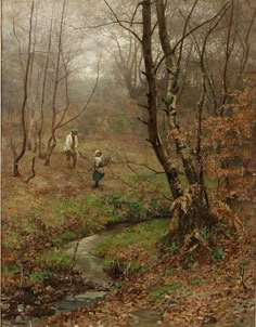 two people walking in the woods by a stream