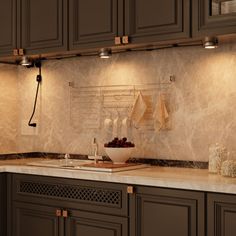 a kitchen with brown cabinets and marble counter tops, along with an overhead light that illuminates the area for cooking utensils