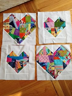 four pieces of quilted fabric are arranged in the shape of hearts