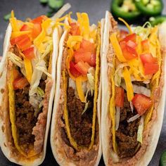 three tacos with toppings on them and the words, double decker tacos