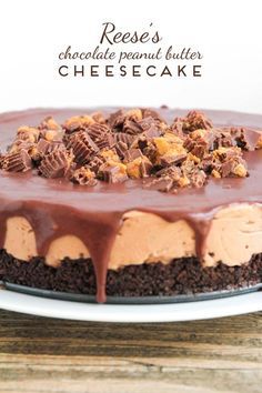 a chocolate peanut butter cheesecake on a white plate with the words reese's chocolate peanut butter cheesecake