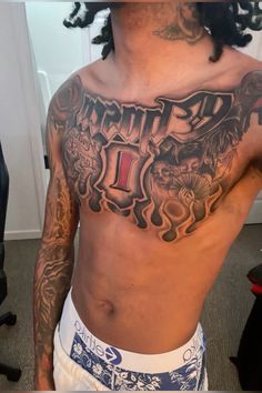 a man with tattoos on his chest