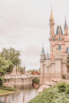 a large castle with towers next to a body of water