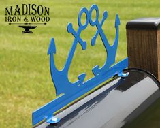 a mailbox with the word iron and wood attached to it in front of a grassy field