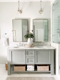 a bathroom with two sinks, mirrors and a rug on the floor in front of it