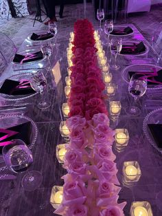 a long table with candles and flowers on it