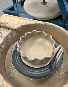 a pottery bowl being made with a fork