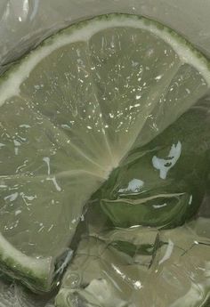 a sliced lime in a plastic bag with water on it's side and some ice