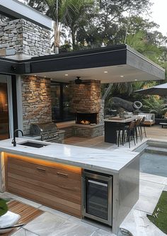 an outdoor kitchen and dining area is shown