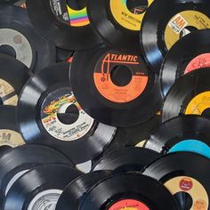 many different colored and black records stacked on top of each other