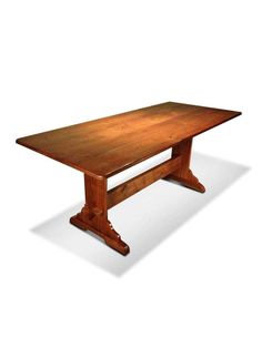 a large wooden table with two legs and an oval shaped center piece on one end