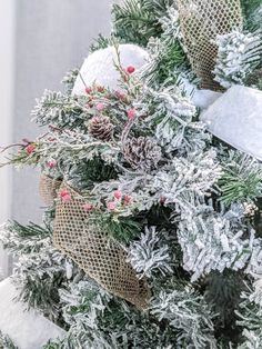 a christmas tree is decorated with burlocks and pine cones