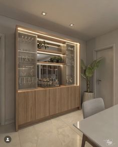 a room with a table, chairs and shelves filled with wine glasses on the wall