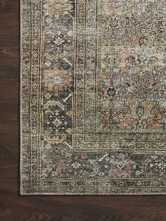 an antique persian rug is shown on a wooden floor with dark wood floors and brown walls