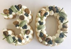 a cake shaped to look like the number 50 with blueberries and cookies on it