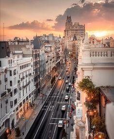 an aerial view of a city street at sunset