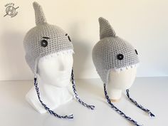 two crocheted hats that have been made to look like a shark's head