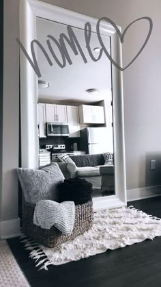 a living room filled with furniture and a large mirror over the top of a door