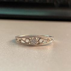 a diamond ring sitting on top of a table