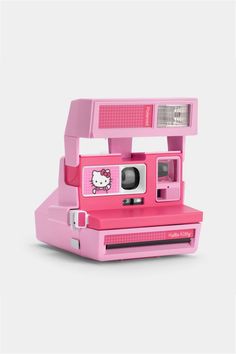 a pink polaroid camera with hello kitty on it