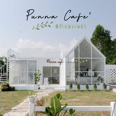 a white house with the words puana cafe on it