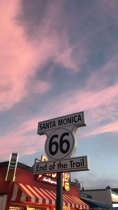 a street sign on the corner of santa monica and 66 end of the trail