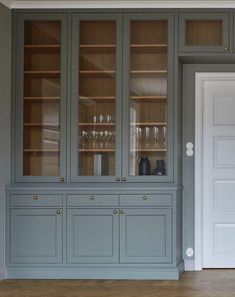 a large gray china cabinet with glass doors