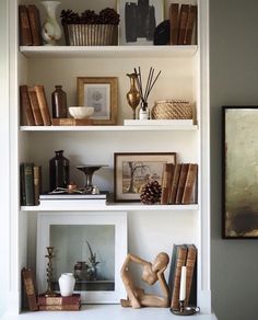 shelves with books, vases and pictures on them