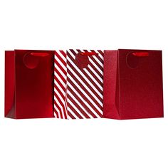 three red and white paper bags with handles