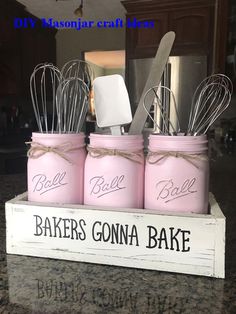 three pink mason jars with utensils in them