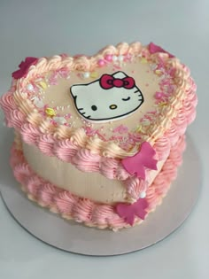 a hello kitty cake with pink icing and sprinkles