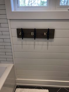 a bathroom with two hooks on the wall