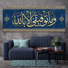 a living room with a blue couch and arabic calligraphy on the wall above it