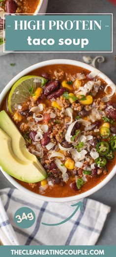 a bowl filled with chili, beans and avocado on top of a table