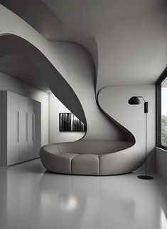 a curved couch sitting in front of a window next to a tall white wall and floor