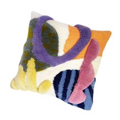 a decorative pillow with multicolored circles on it's sides and a white background