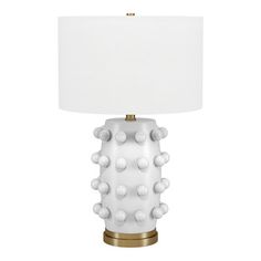 a lamp with white balls on it and a gold base